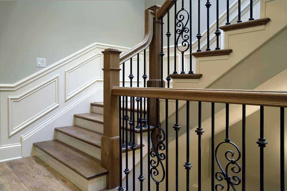 Wrought iron balusters complement the wrought iron used in the foyer’s lighting fixtures.