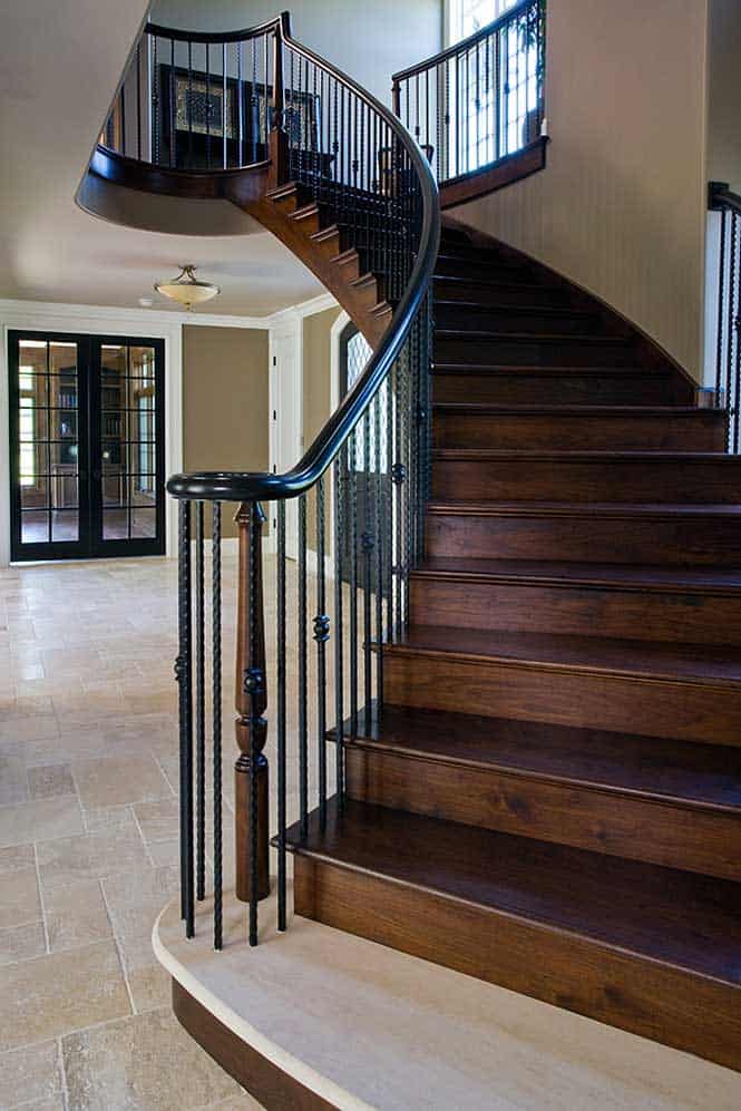 French County Estate houses a Curved Entry Staircase with Wrought Iron Railings