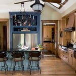 The blue painted maple armoire cabinet that houses the refrigerator adds a bold pop of color to the kitchen.