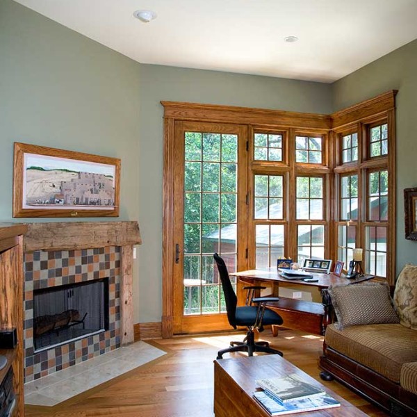 A cozy home office space is made even cozier with a fireplace.