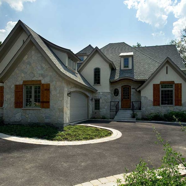 The unexpected mix of stucco and stone create an eclectic look for the home’s exterior.