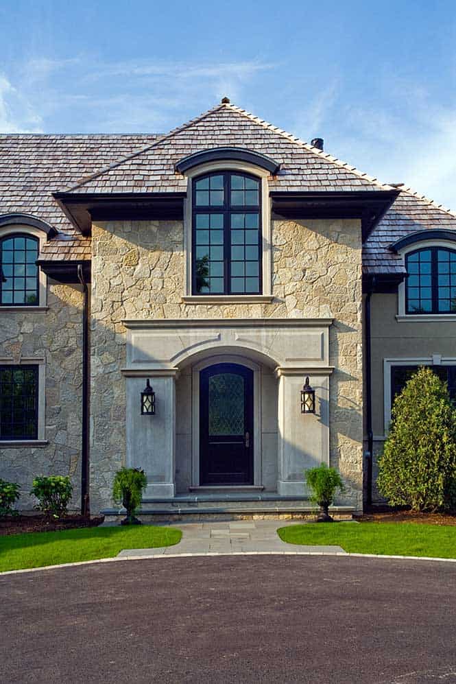 Large Arched Front Entry Windows Reflect the French Provincial Design