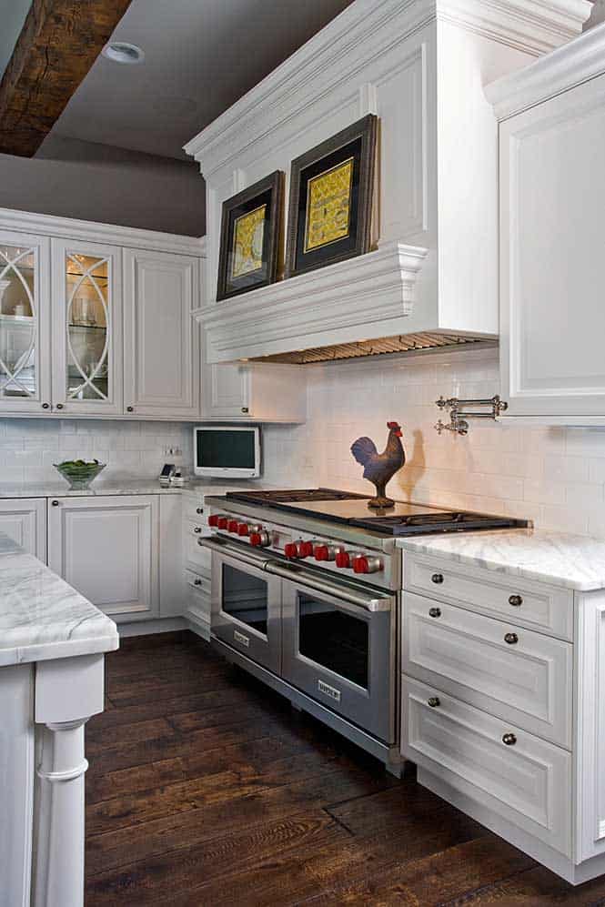 Kitchen has a Chefs Double Oven with White Backsplash