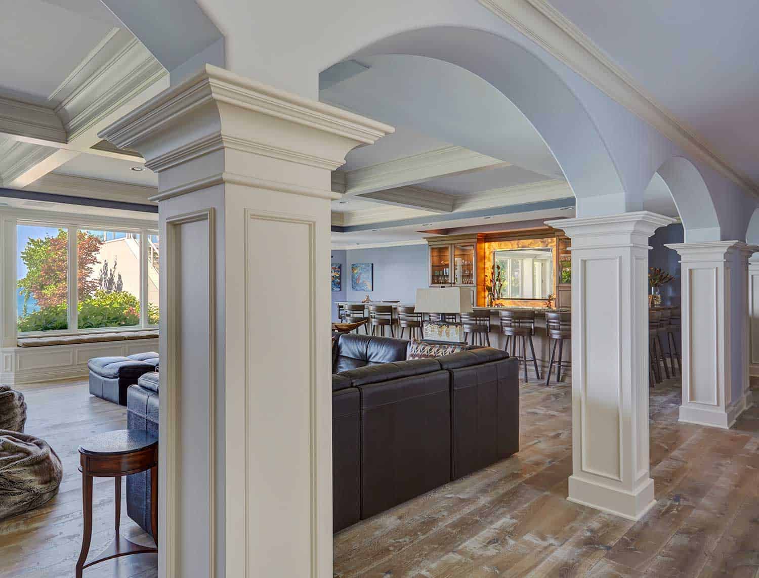 paneled-columns-connect-arched-openings-lower-level-family-room