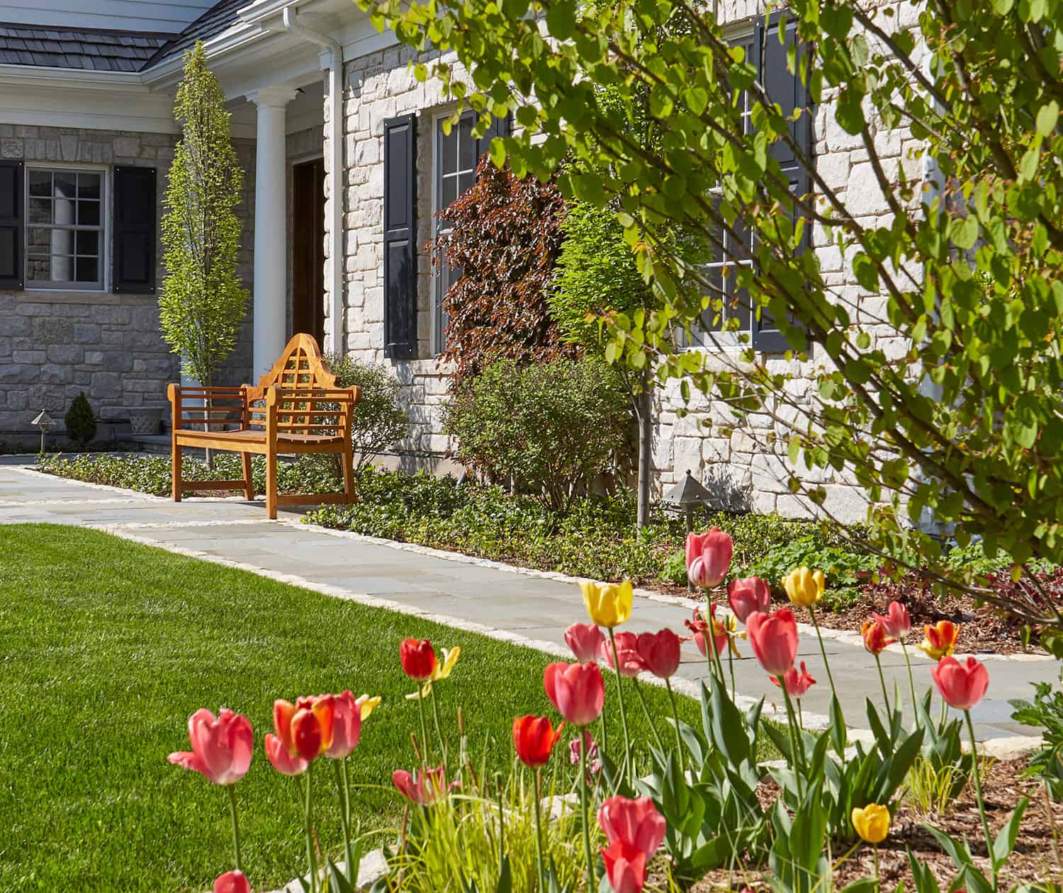 bluestone-walkway-tulips-foreground-wooden-giverny-bench