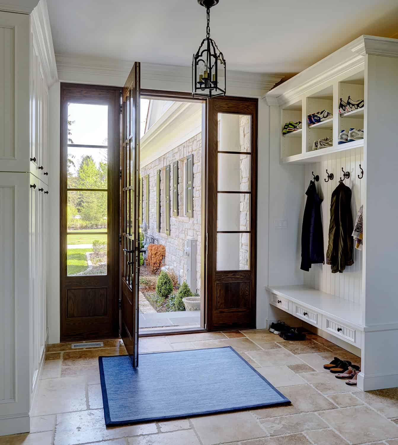 mudroom-entry-travertine-flooring-built-in-cabinetry-bench-seating