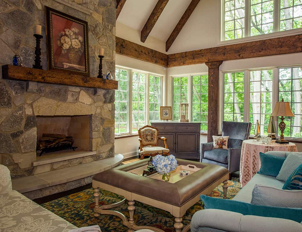 two story stone fireplace in greatroom with beamed ceiling