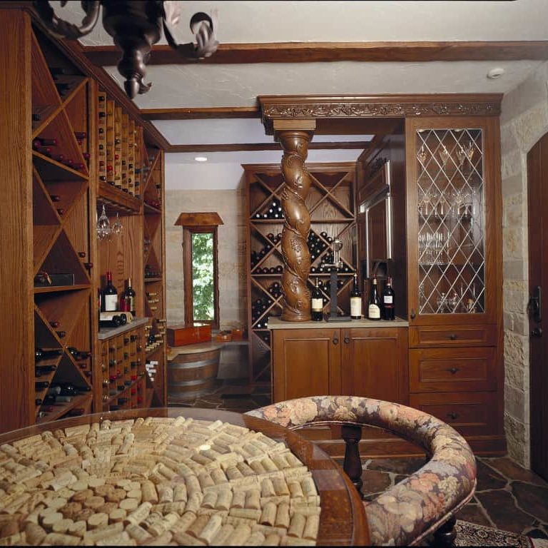 A wine cellar with wooden wine racks and a tabletop fashioned from wine corks