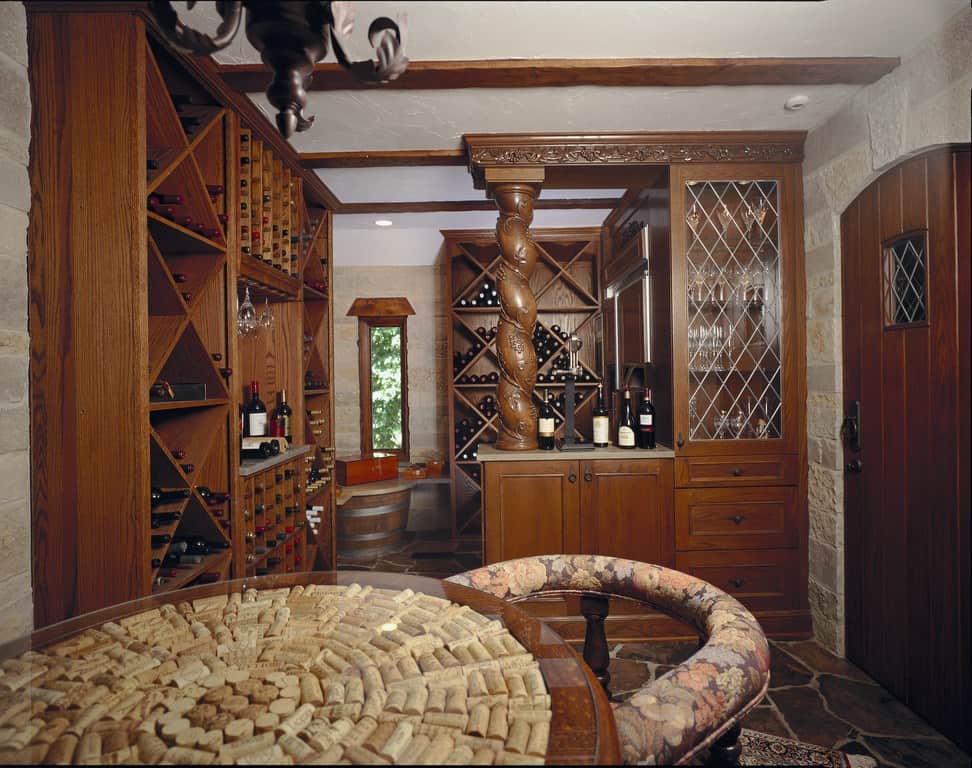 A wine cellar with wooden wine racks and a tabletop fashioned from wine corks