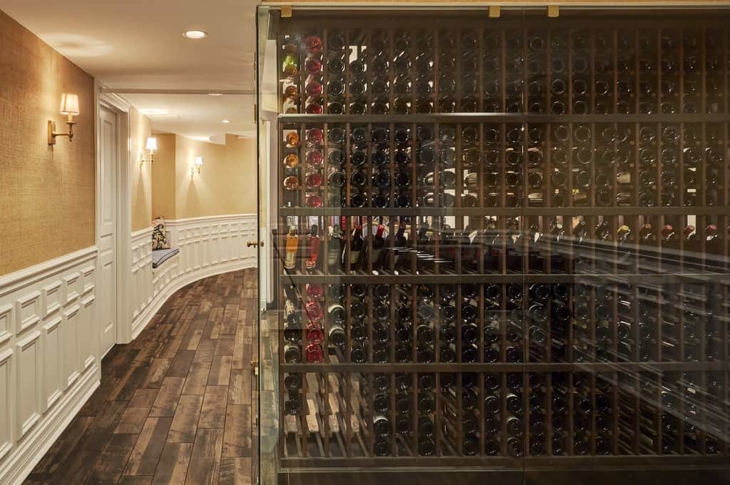 A metal glass wine storage unit in a custom remodeled basement