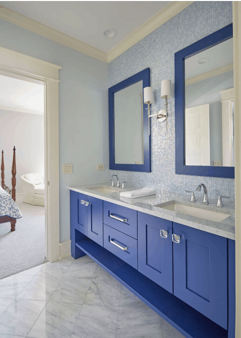Blue themed jack and jill bathroom with blue trimmed mirror