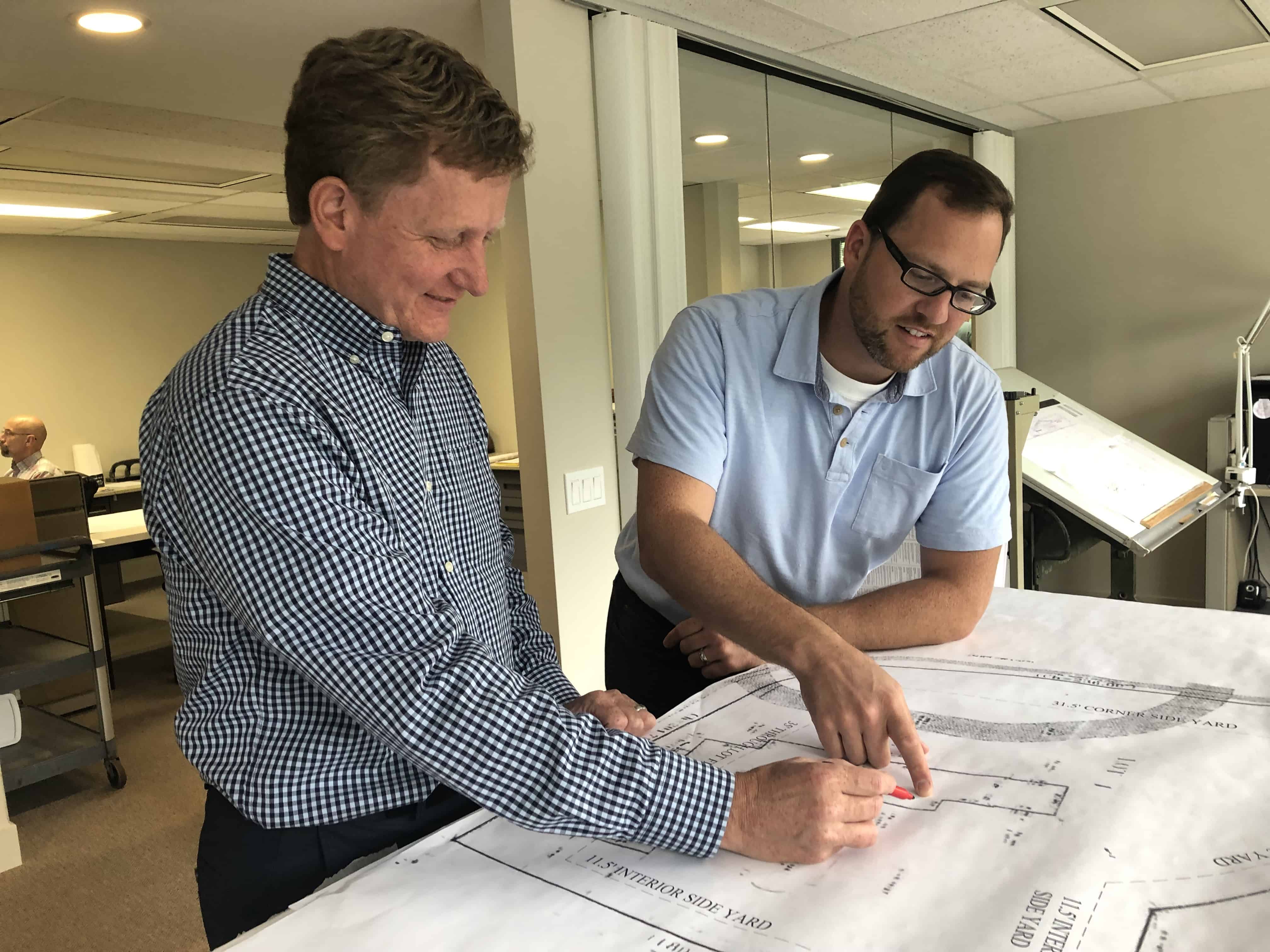 seven-signature-review architects reviewing plans