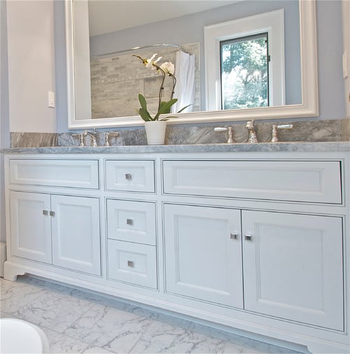 Blue room with a jack and jill vanity with separate storage containers.