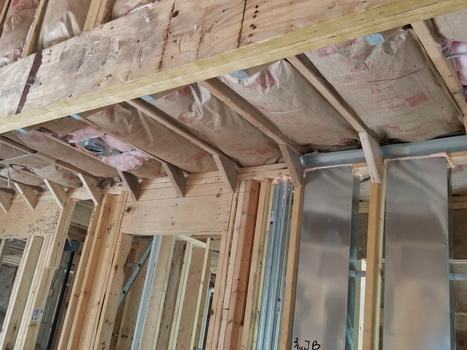 BAT insulation inside wooden framing of a house's walls and ceiling