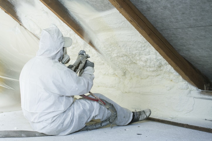 Man spraying polyurethane foam for roof