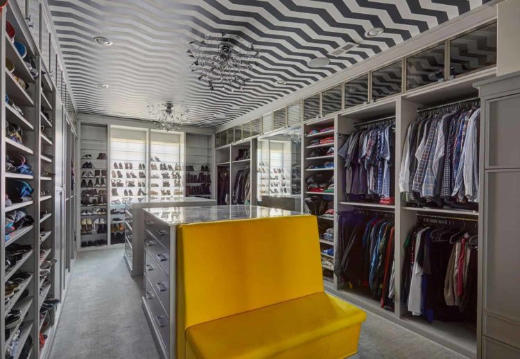 custom-closet-with-chevron-ceiling-and-open-display-shelves closet with open display shelves and chevron ceiling detail