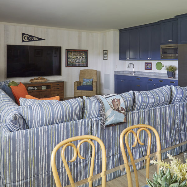 basement-family-room-with-blue-cabinetry-large-sectional-sofa striped blue sectional sofa in lower level family room