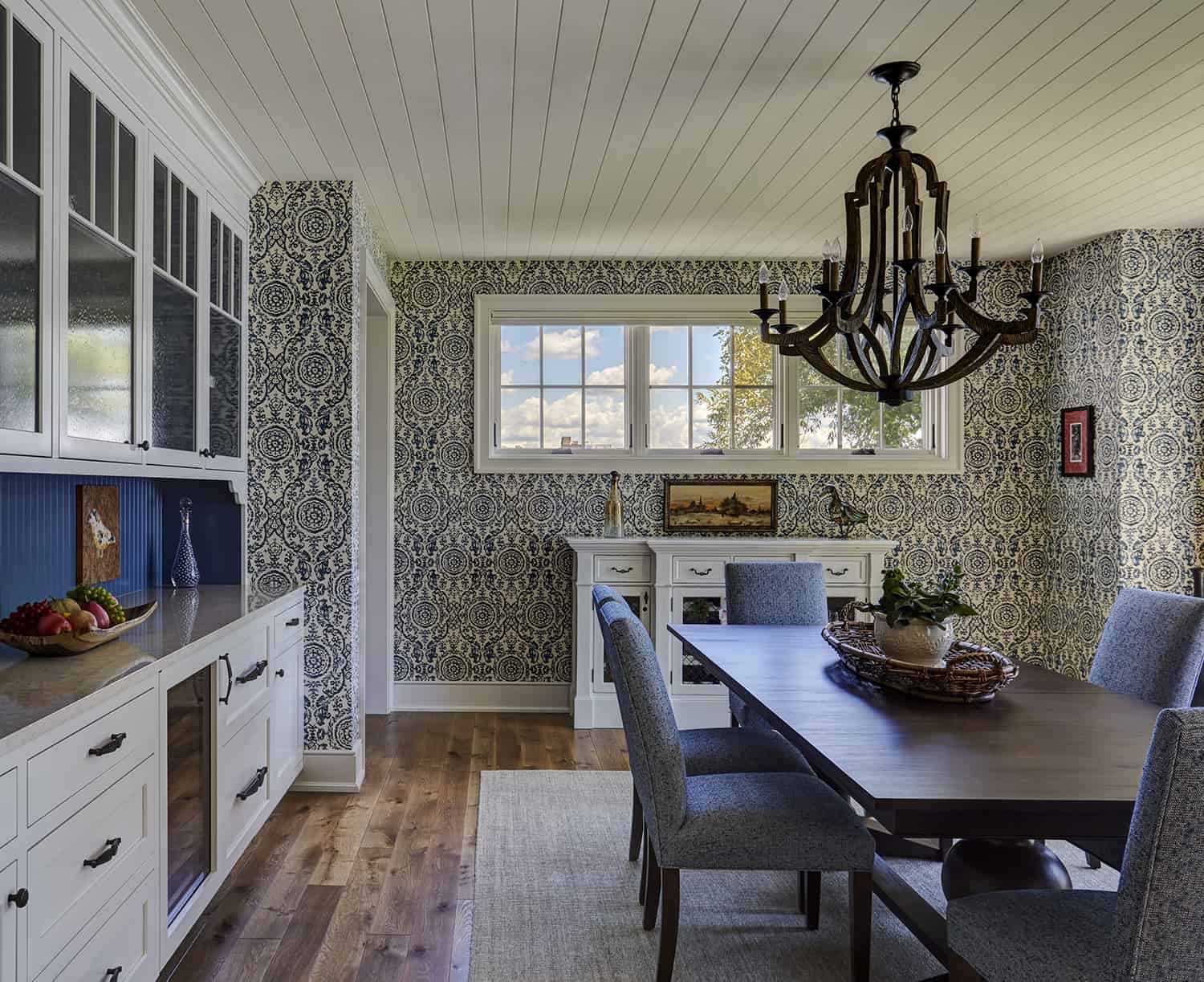dining room with shiplap ceiling and patterned wallpaper