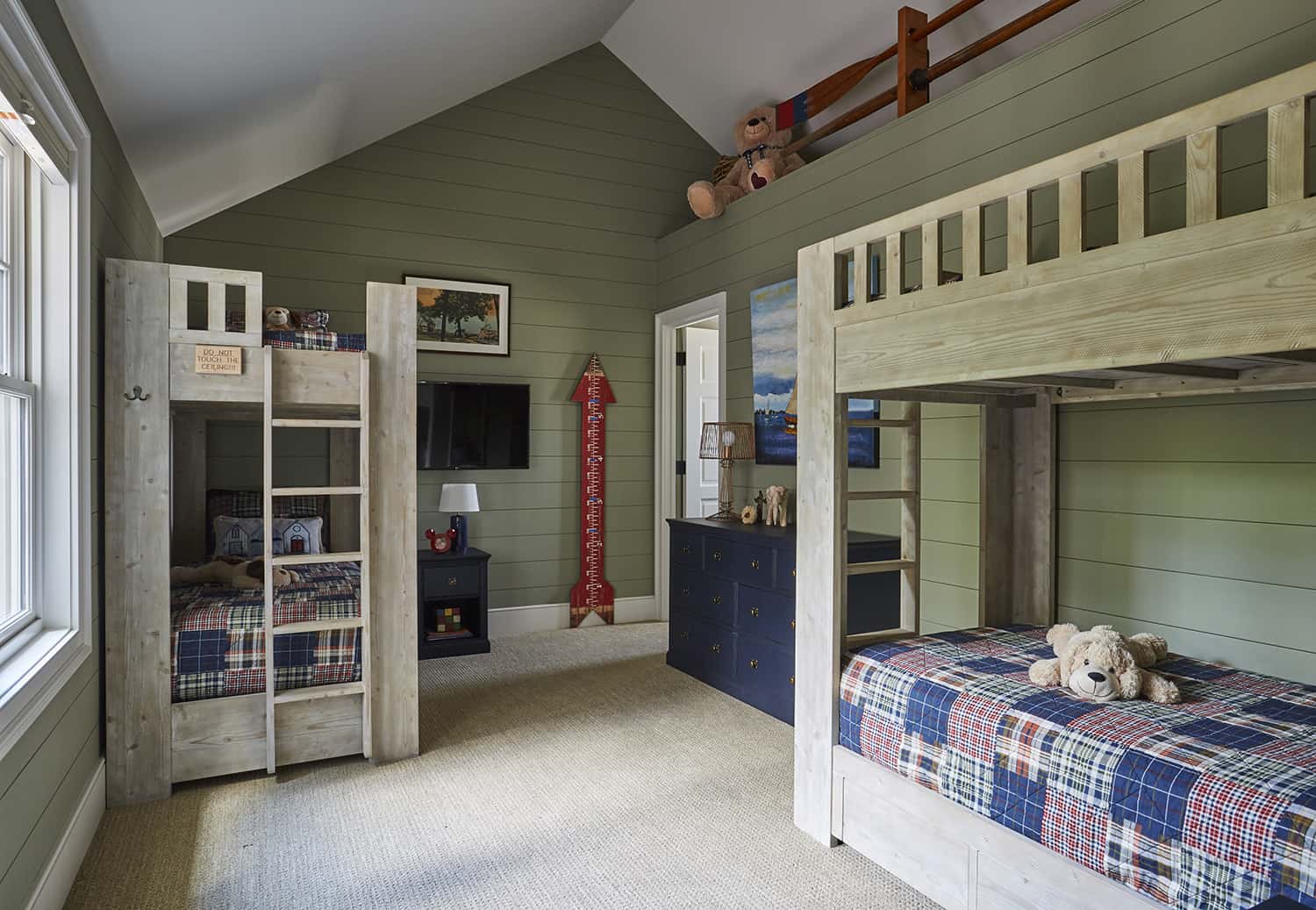 bunkroom with green shiplap walls