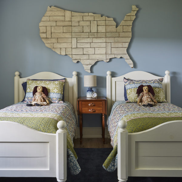childs-bedroom-two-twin-beds-large-us-map twin beds with dolls on bed and large wooden us map