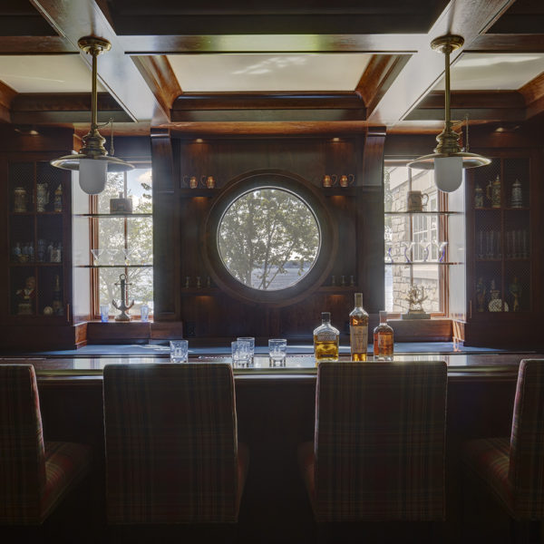 circular-window-with-view-of-lake-geneva-from-home-bar round porthole window with view to lake geneva
