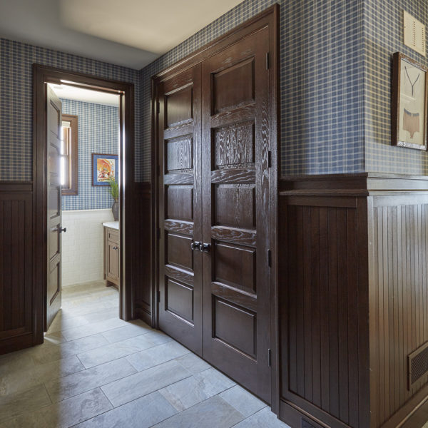 dark-wood-recessed-panel-french-door-detail mudroom closet with dark wood recessed panel french doors