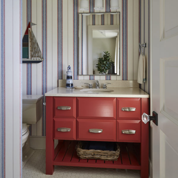 red-vanity-striped-wallpaper-hex-tile-floor red vanity with open shelving and striped wall covering