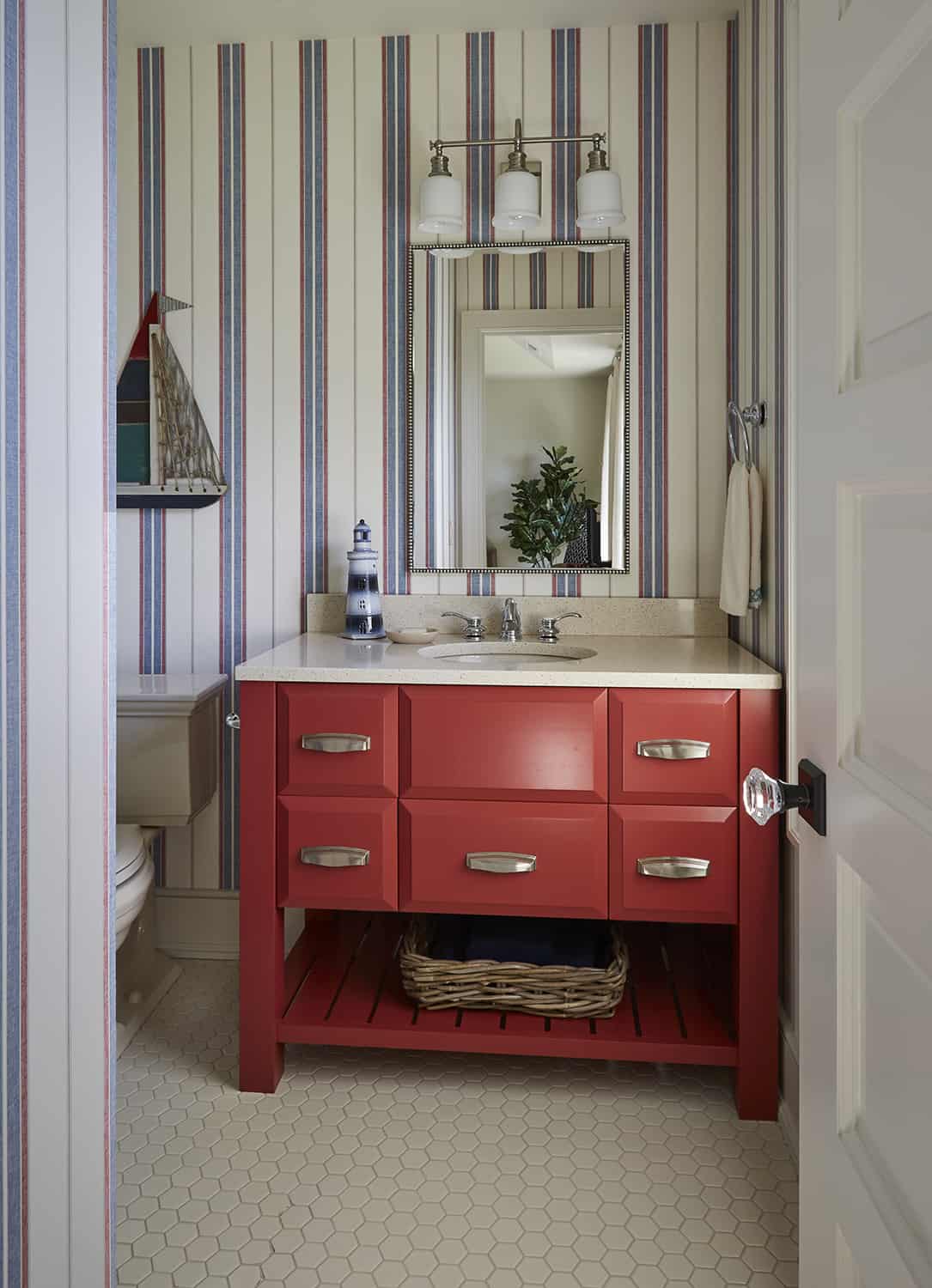 red vanity with open shelving and striped wall covering