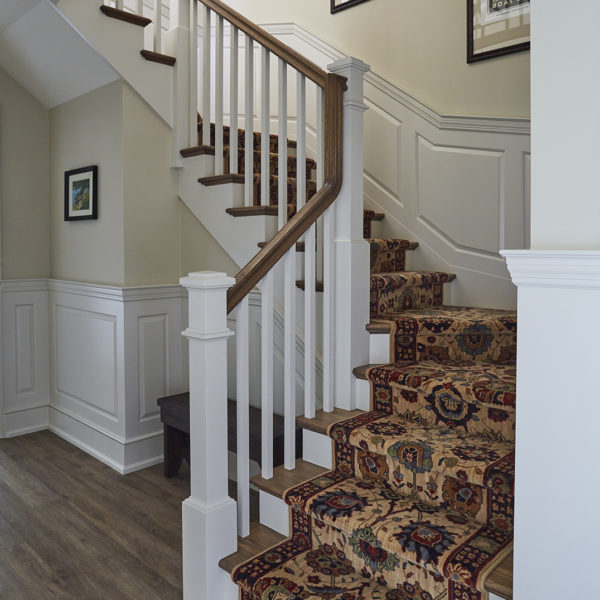 staircase-detail-with-carpeted-runner staircase with carpet runner, wood treads, painted baluster