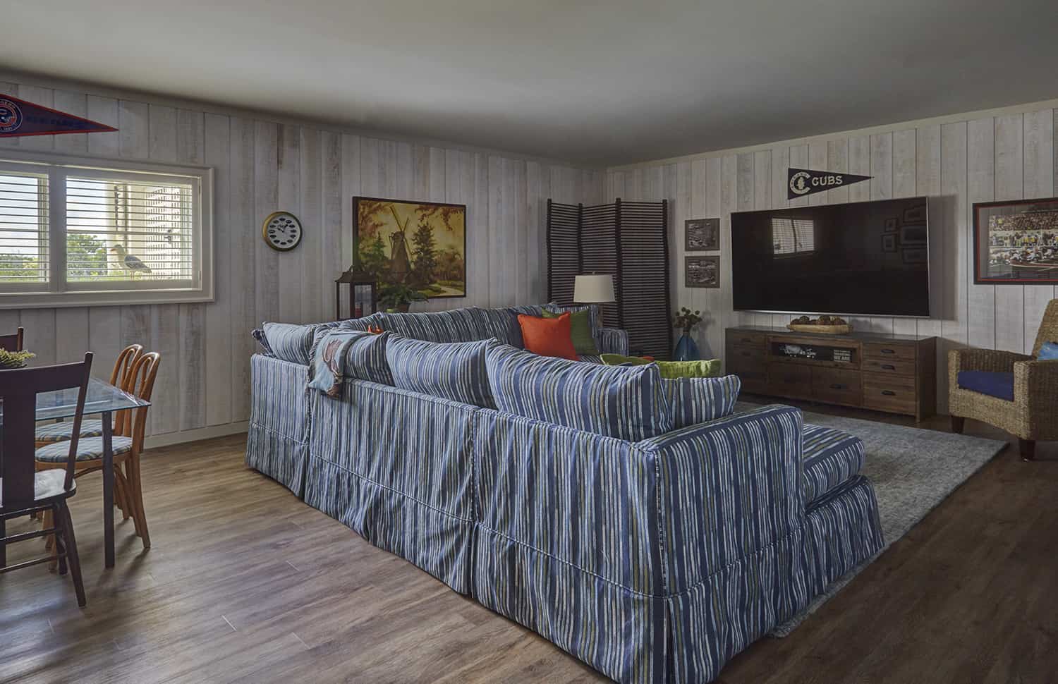 striped sectional in lower level tv room