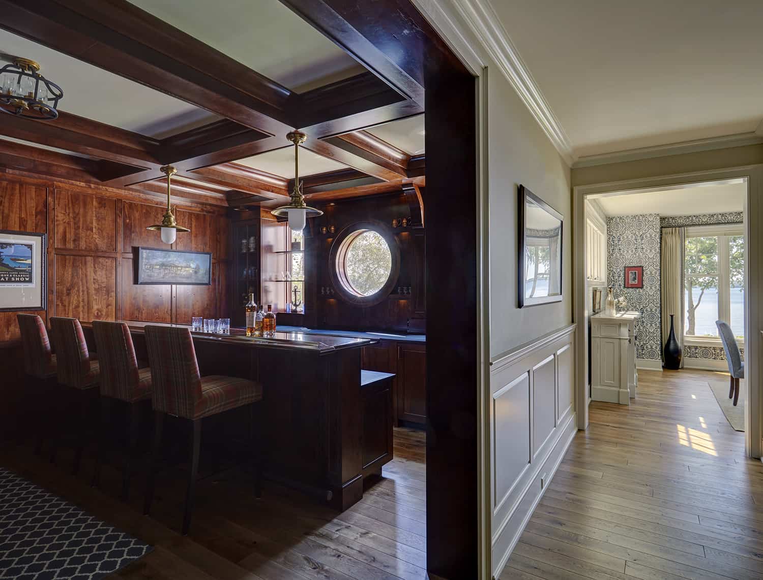 home bar with dark wood paneling