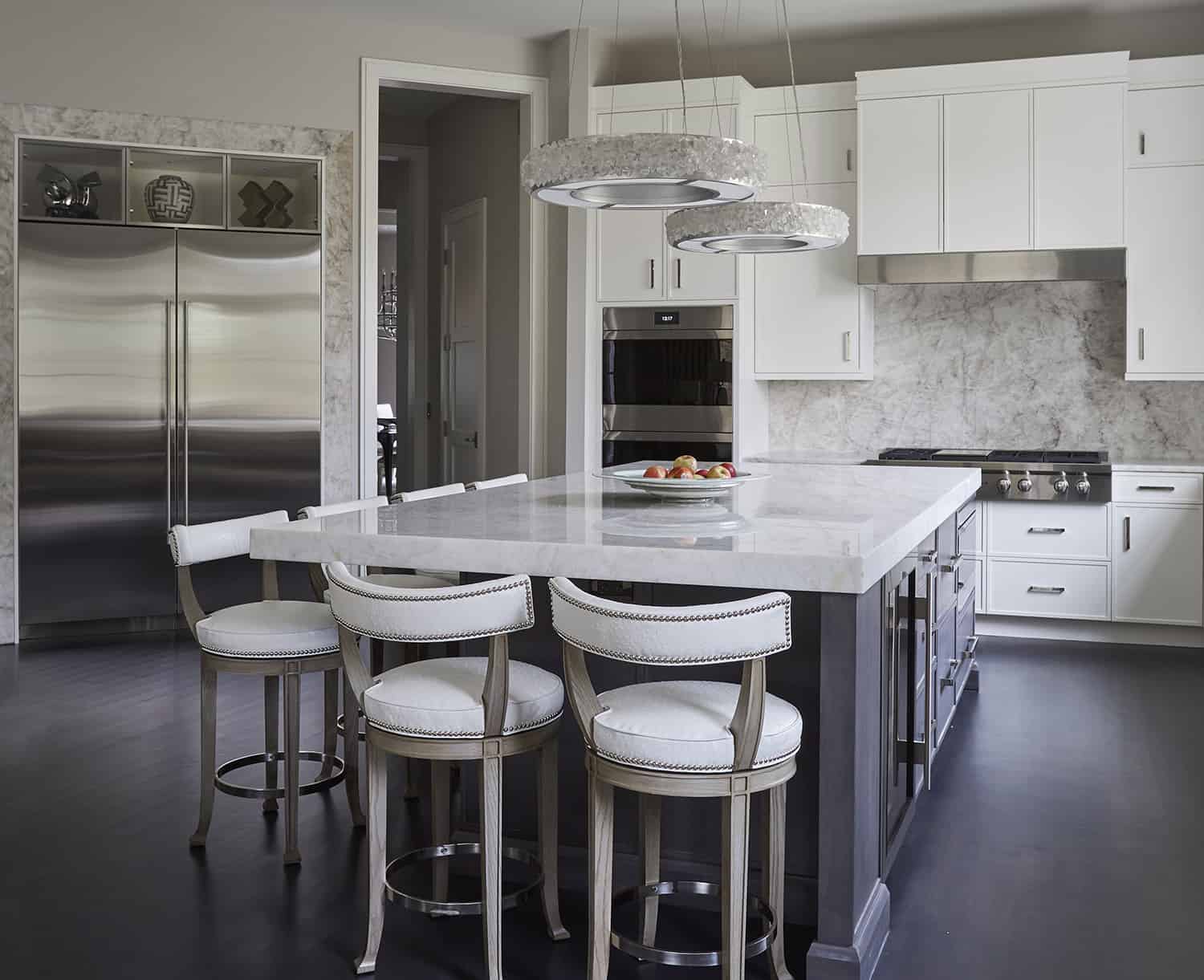 contemporary kitchen with dark island and white perimeter cabinets