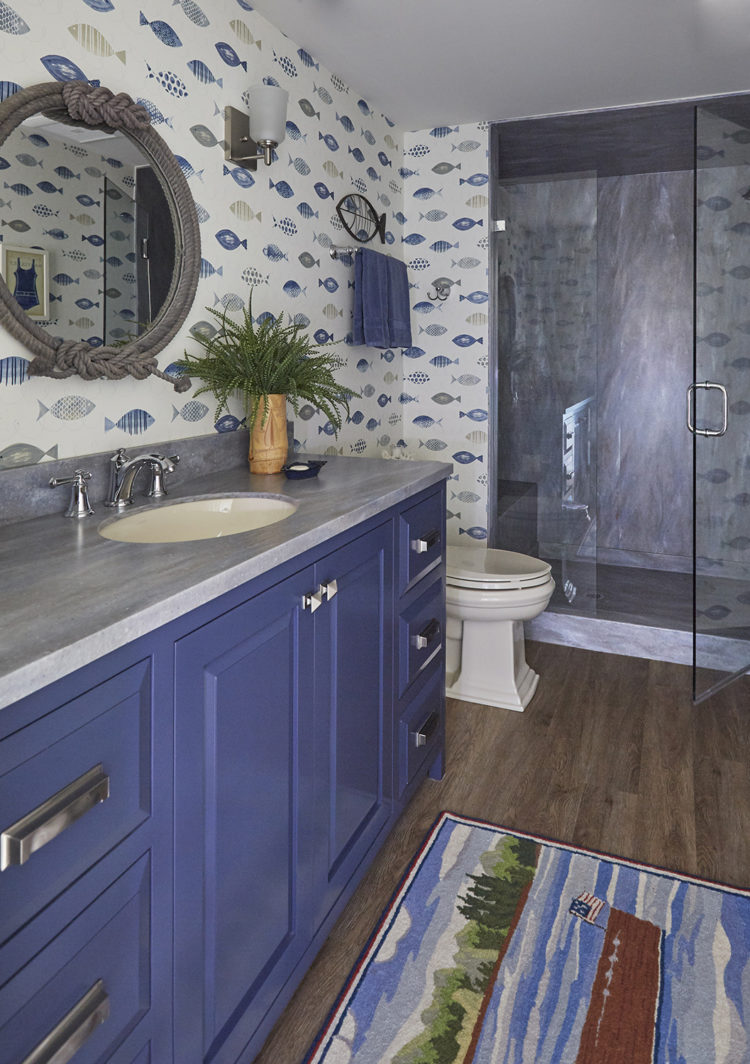 blue vanity with whimsical fish wallpaper