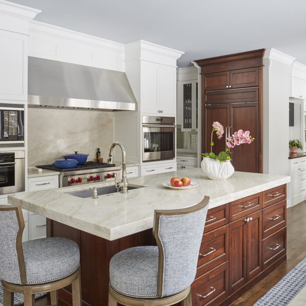 two tone kitchen with upholstered stools at island