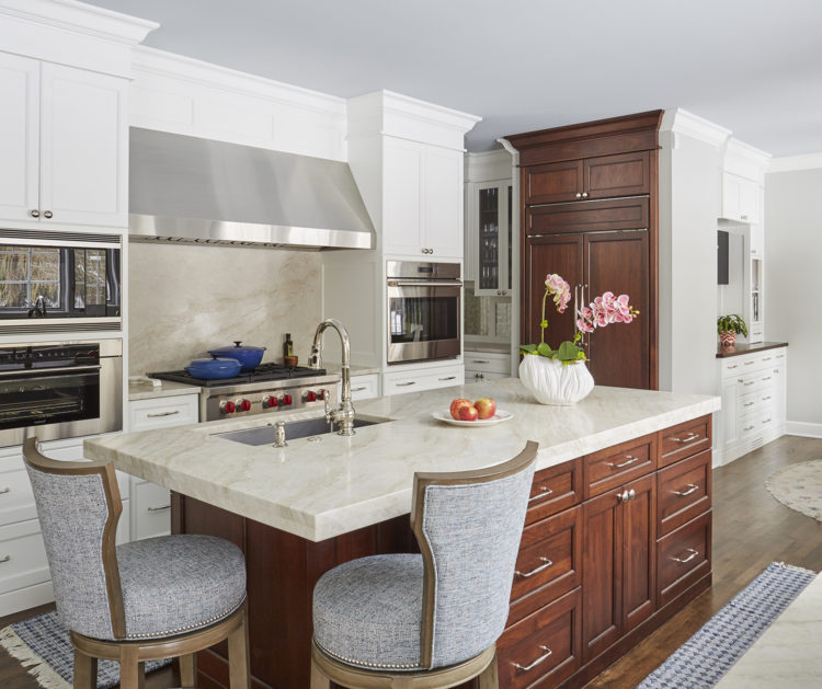 two tone kitchen with upholstered stools at island
