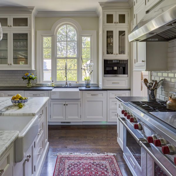arched topped window over sink in classic white kitchen