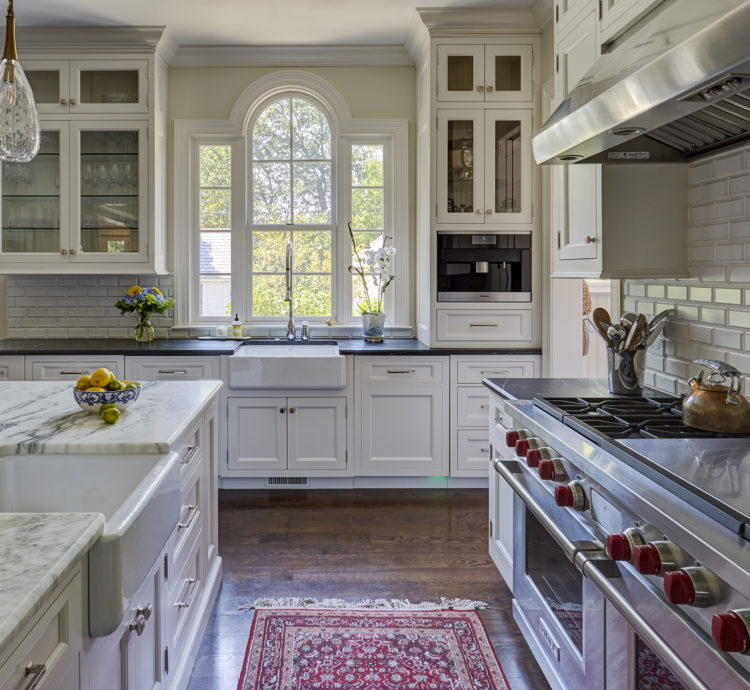 arched topped window over sink in classic white kitchen