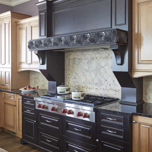 heavily carved dark wood range hood