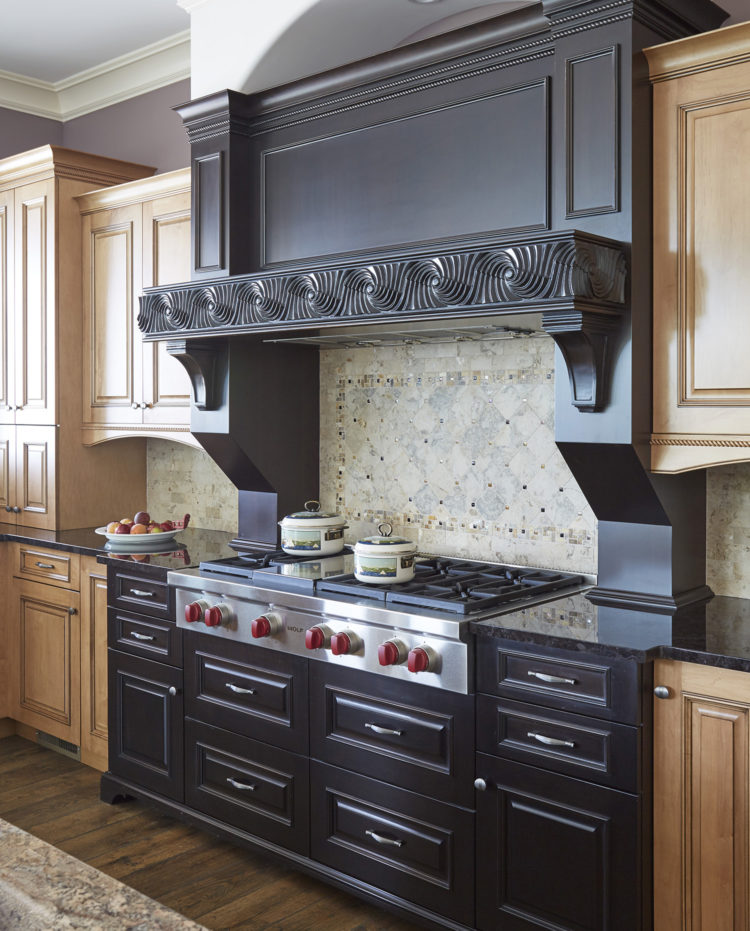 heavily carved dark wood range hood