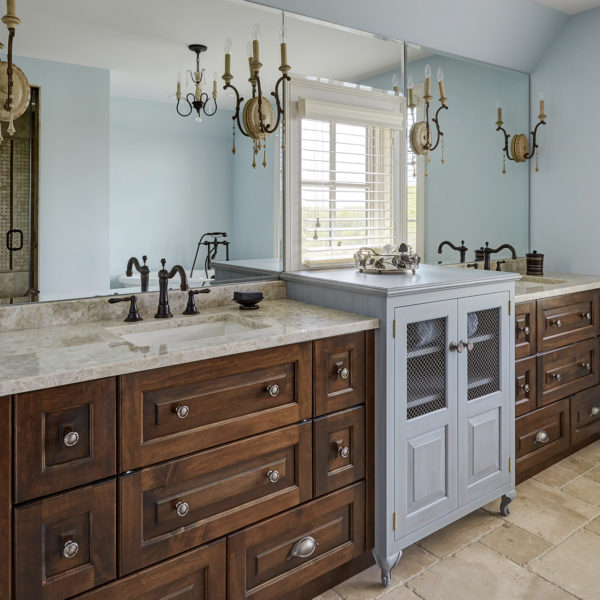 french country bathroom with blue center cabinet