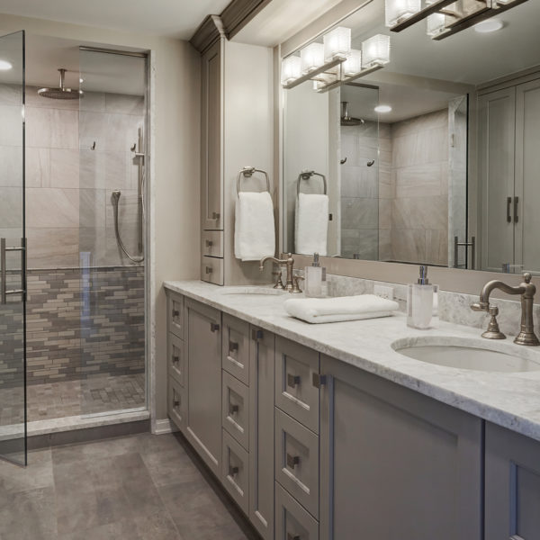 recessed panel gray cabinets with full length mirror backsplash