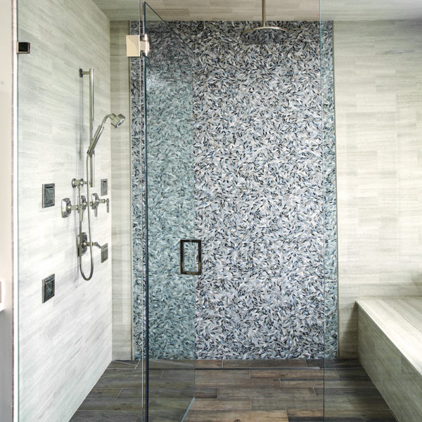 master shower with luxurious tile wall