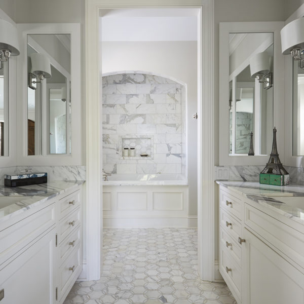 white bathroom cabinetry with his and her sinks