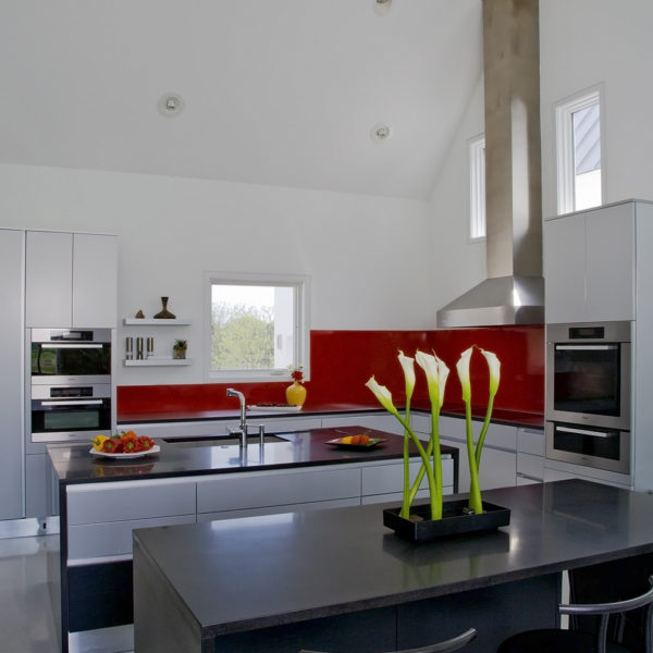 red and black contemporary kitchen with two islands