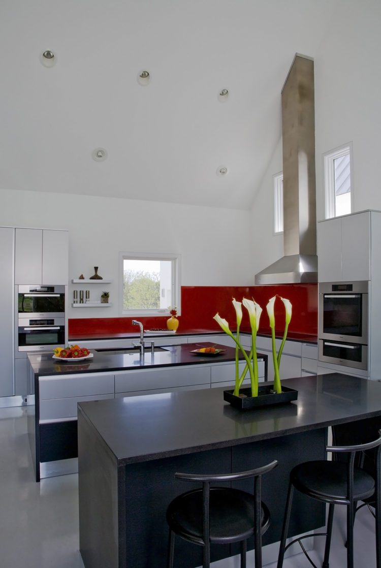 red and black contemporary kitchen with two islands