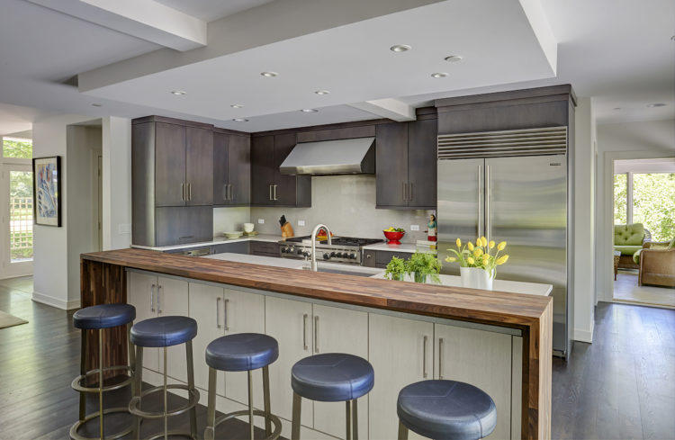 transitional kitchen with waterfall edge wood countertop