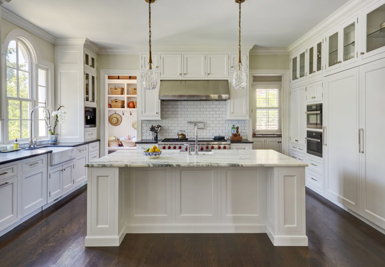 white kitchen with contrasting countertops on island and perimeter cabinets