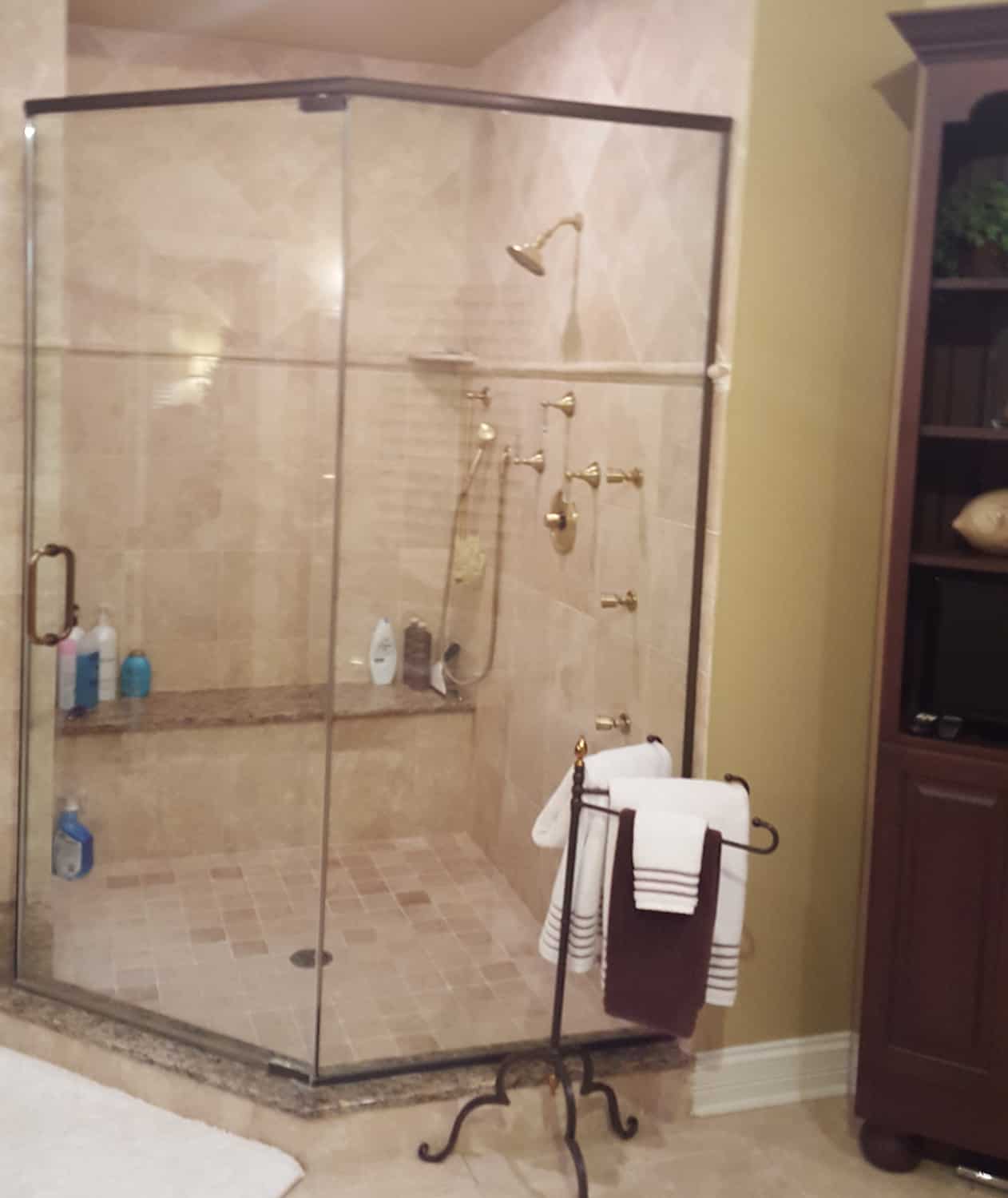 dated shower with glass walls