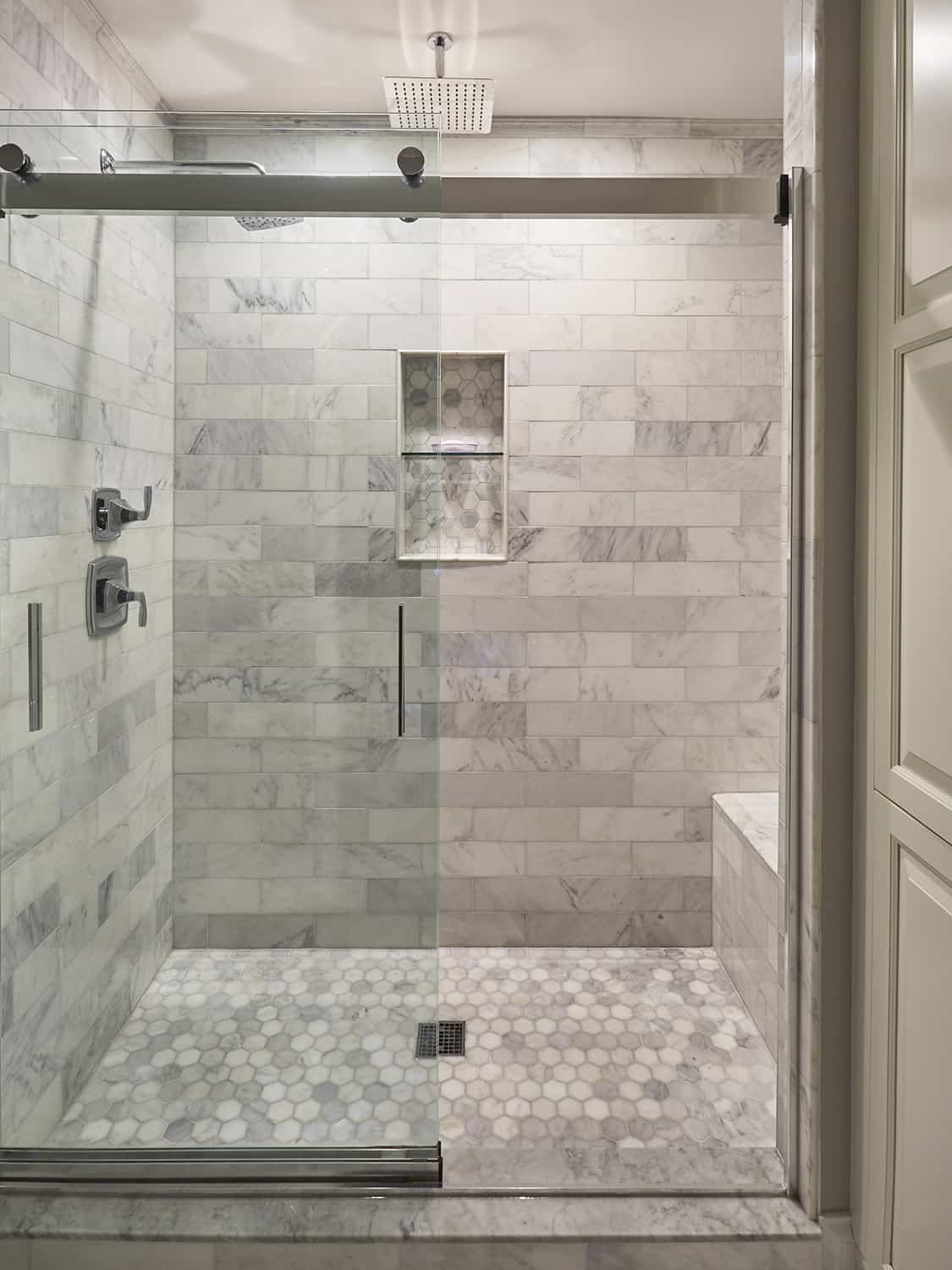 luxurious master shower clad in marble