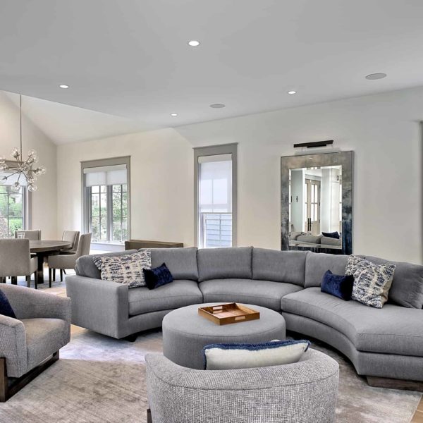 large open concept living area with semi circular sofa large open concept living area with semi circular sofa